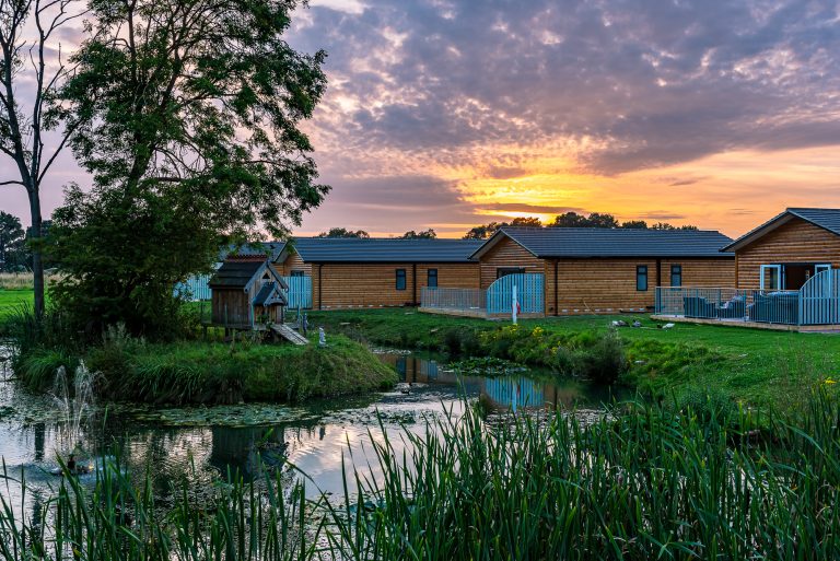hot tub log cabins in York at sunset